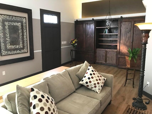 living room featuring hardwood / wood-style floors and a barn door