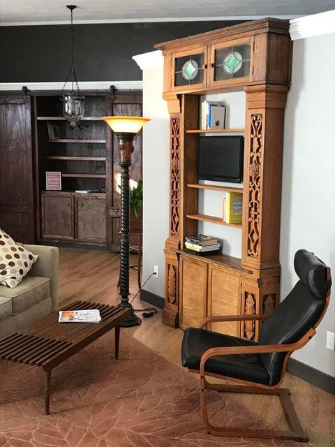 sitting room featuring a chandelier and wood-type flooring