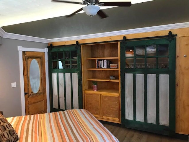 bedroom featuring ceiling fan, dark hardwood / wood-style floors, and ornamental molding