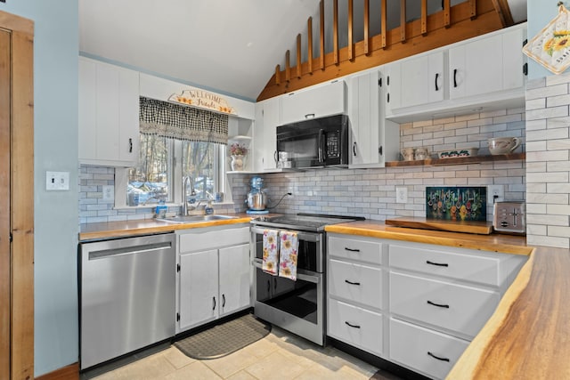 151 Mountain View Dr, Acton, ME 04001 - kitchen with white cabinetry, sink, stainless steel appliances, lofted ceiling, and light tile patterned floors
