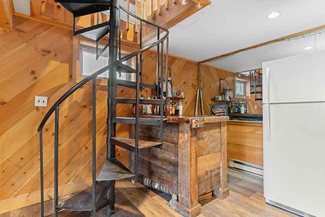 151 Mountain View Dr, Acton, ME 04001 - stairway with wooden walls, hardwood / wood-style floors, indoor bar, and a baseboard heating unit