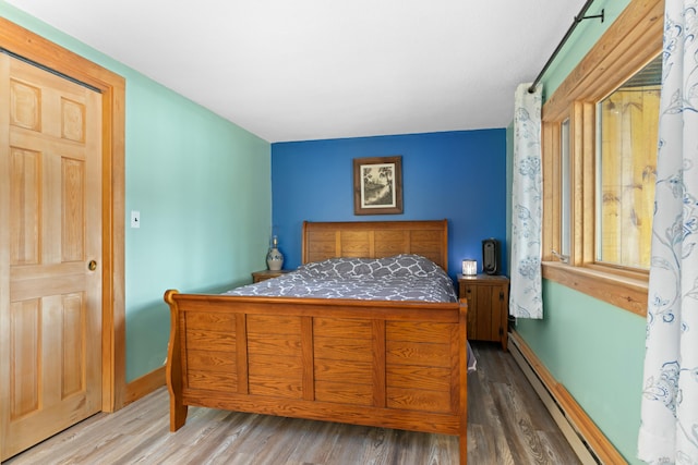 151 Mountain View Dr, Acton, ME 04001 - bedroom featuring wood-type flooring and a baseboard radiator