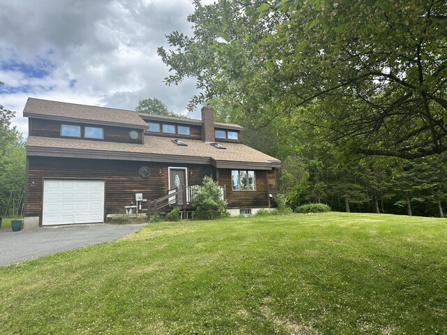 119 Fenderson Hill Hill N, Wilton, ME 04294 - view of front facade featuring a front yard, asphalt driveway, an attached garage, and a chimney