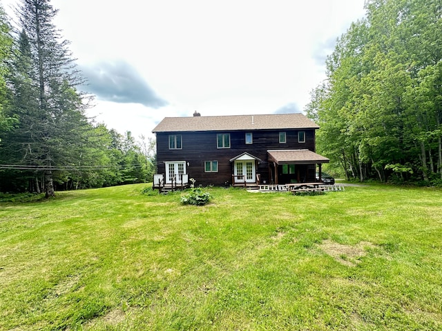 119 Fenderson Hill Hill N, Wilton, ME 04294 - rear view of house featuring french doors, a yard, and a chimney