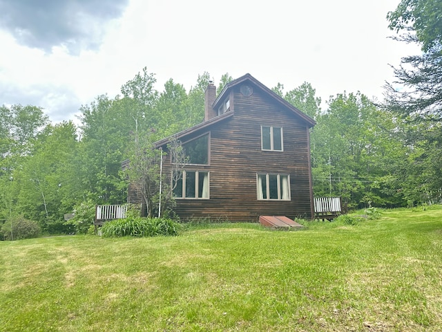 119 Fenderson Hill Hill N, Wilton, ME 04294 - view of side of home with a chimney, a yard, and a deck