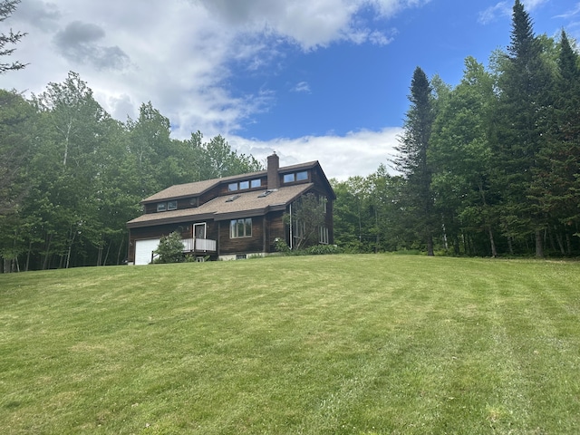 119 Fenderson Hill Hill N, Wilton, ME 04294 - view of front of property with an attached garage, a front yard, a chimney, and a wooded view