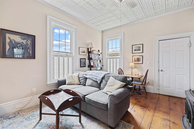 living room with dark hardwood / wood-style floors and crown molding