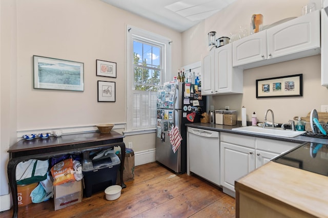 kitchen featuring white dishwasher, dark hardwood / wood-style flooring, white cabinets, and sink