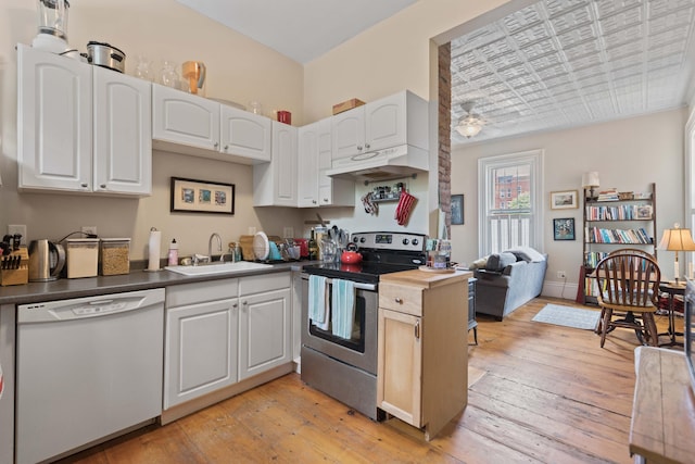 kitchen with sink, white dishwasher, light hardwood / wood-style floors, stainless steel electric range, and white cabinets