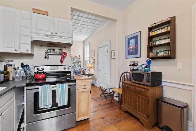 kitchen with white cabinets, stainless steel appliances, and dark wood-type flooring