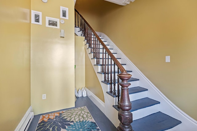 stairs with a baseboard radiator