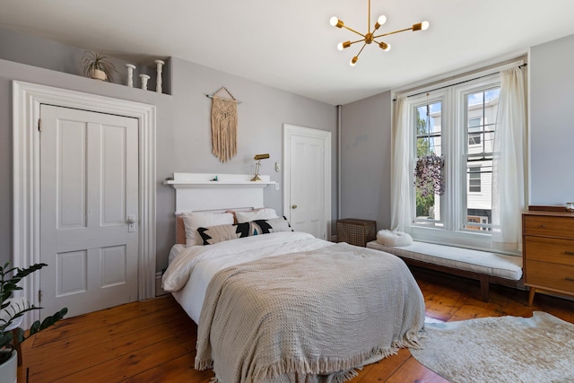 bedroom featuring hardwood / wood-style floors and a notable chandelier