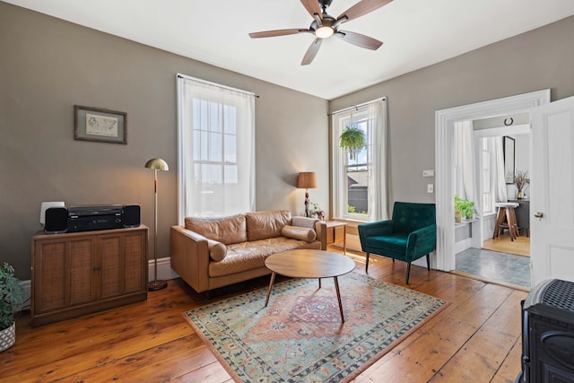 living room with ceiling fan and hardwood / wood-style flooring