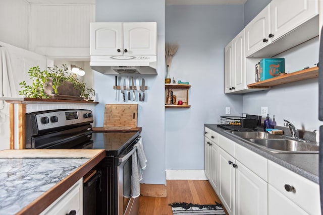 kitchen featuring electric range, light hardwood / wood-style flooring, white cabinets, and sink