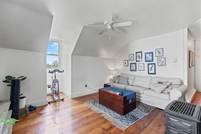 living room with hardwood / wood-style flooring, vaulted ceiling, ceiling fan, and a baseboard heating unit