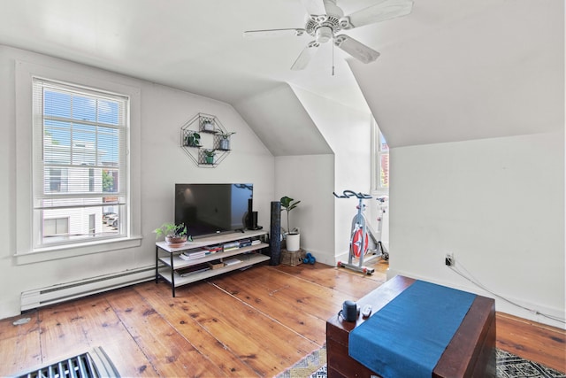 living room featuring wood-type flooring, vaulted ceiling, baseboard heating, and ceiling fan