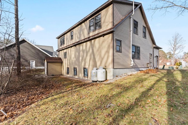 view of side of home with a yard