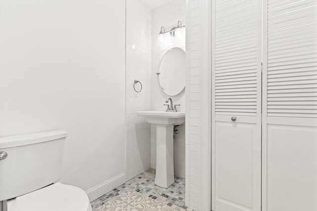 bathroom with sink, tile patterned flooring, and toilet