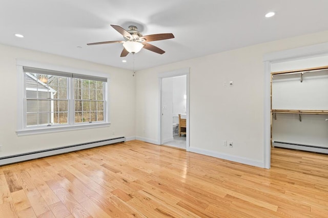 interior space with light hardwood / wood-style flooring, baseboard heating, and ceiling fan