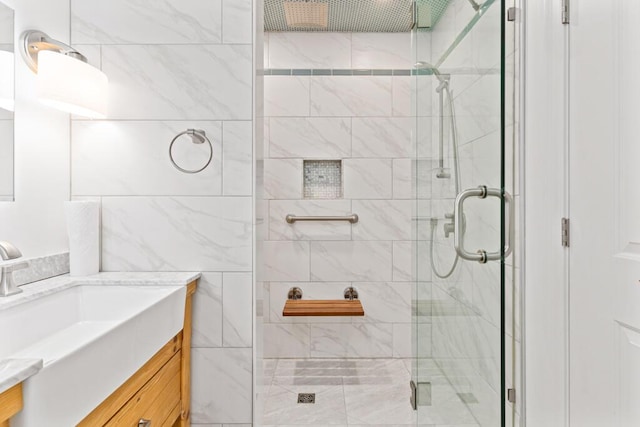 bathroom with vanity and a shower with shower door