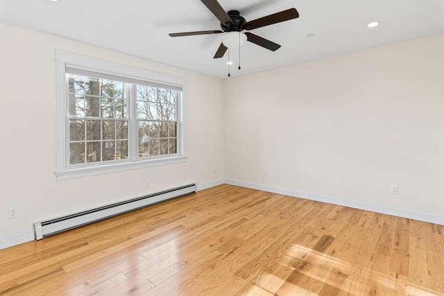 spare room with ceiling fan, light hardwood / wood-style floors, and baseboard heating