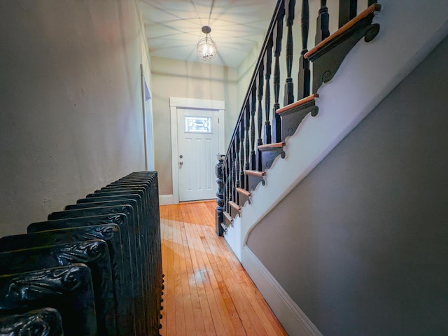 entryway featuring wood-type flooring and an inviting chandelier