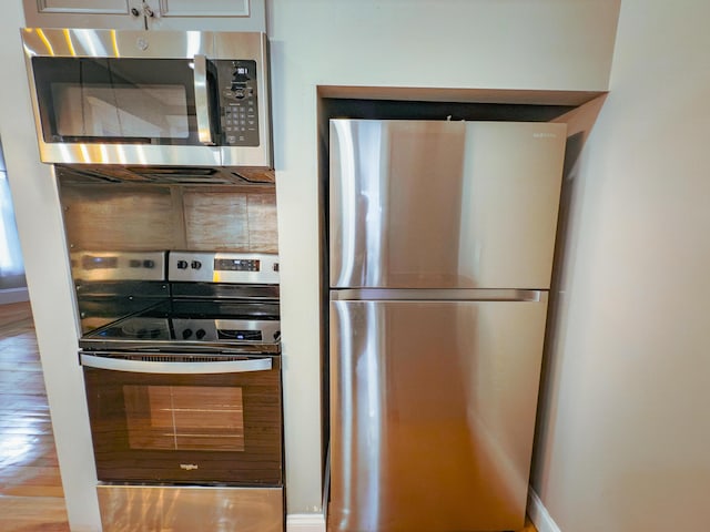 kitchen with wood-type flooring and appliances with stainless steel finishes