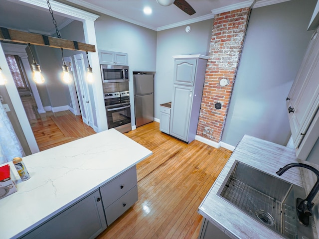 kitchen with gray cabinets, sink, and appliances with stainless steel finishes