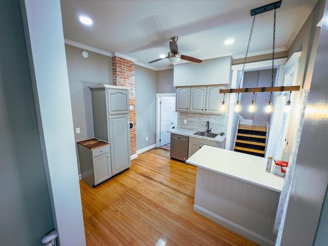 kitchen featuring light hardwood / wood-style flooring, stainless steel dishwasher, backsplash, pendant lighting, and ornamental molding