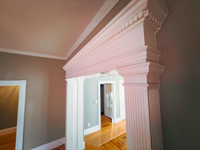 corridor with crown molding and light hardwood / wood-style floors