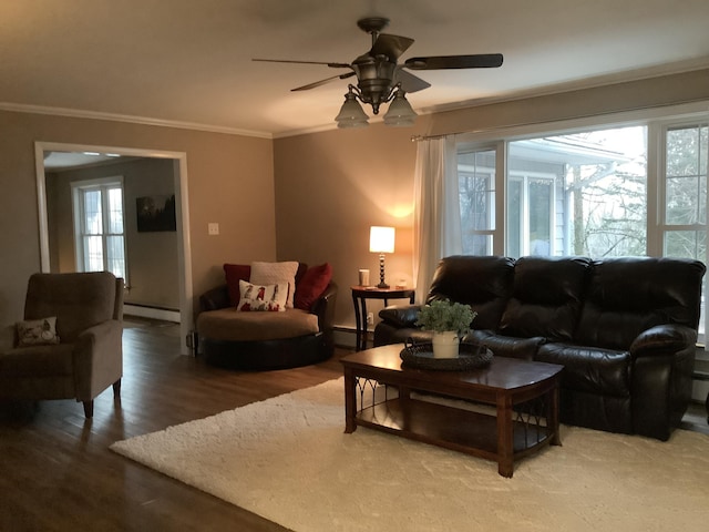 living room with baseboard heating, ceiling fan, wood-type flooring, and ornamental molding