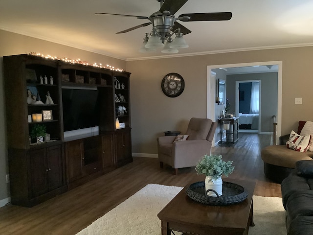 living room with ceiling fan, dark hardwood / wood-style flooring, and crown molding