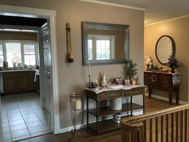 hall featuring tile patterned floors and crown molding