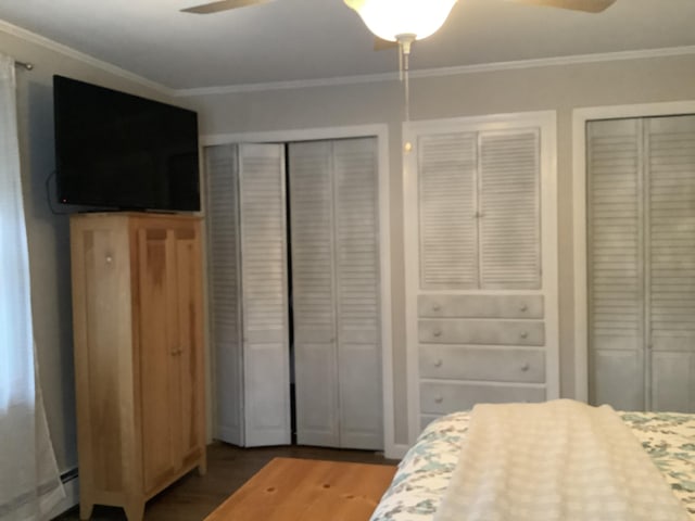 bedroom with multiple closets, ceiling fan, a baseboard radiator, and ornamental molding