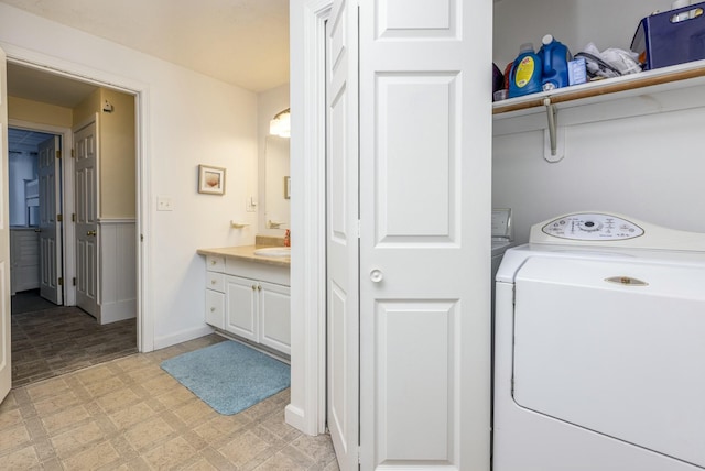 clothes washing area featuring washer / dryer and sink