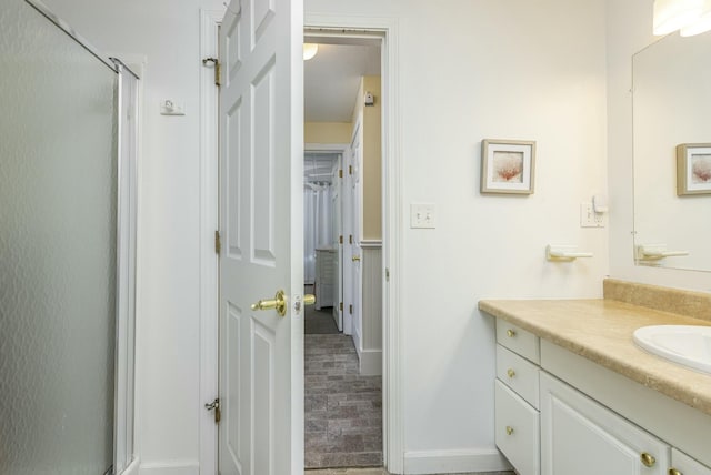 bathroom featuring vanity and an enclosed shower