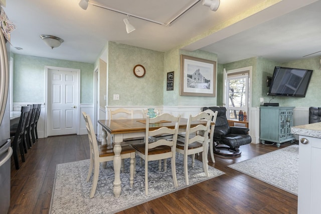 dining room featuring rail lighting and dark wood-type flooring