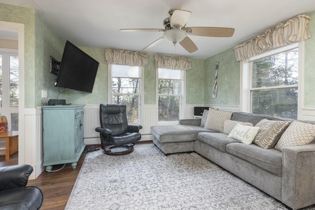 living room with ceiling fan, dark wood-type flooring, and a baseboard heating unit