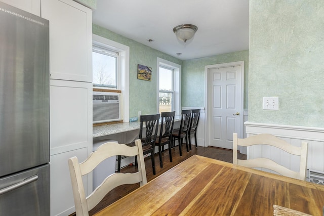 dining room with dark hardwood / wood-style flooring, cooling unit, and built in desk