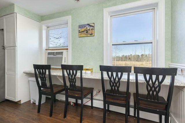 dining area with cooling unit and dark wood-type flooring