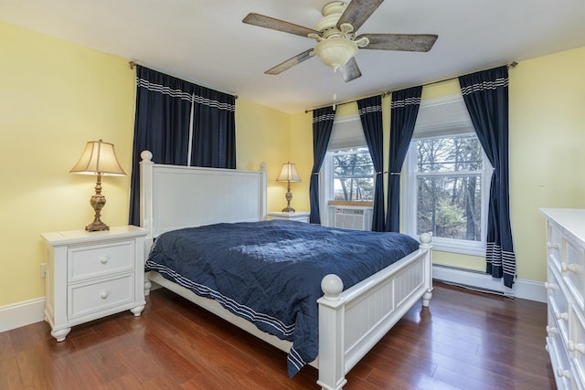 bedroom featuring cooling unit, baseboard heating, ceiling fan, and dark wood-type flooring