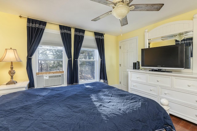 bedroom with ceiling fan, dark hardwood / wood-style flooring, and cooling unit