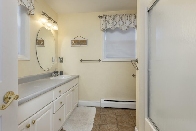 bathroom featuring baseboard heating, tile patterned flooring, and vanity