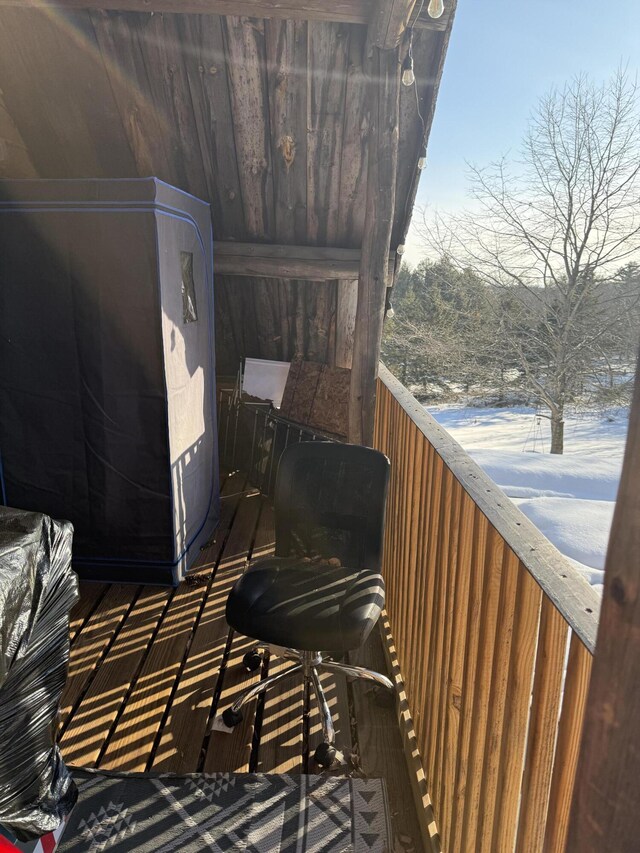 view of snow covered back of property