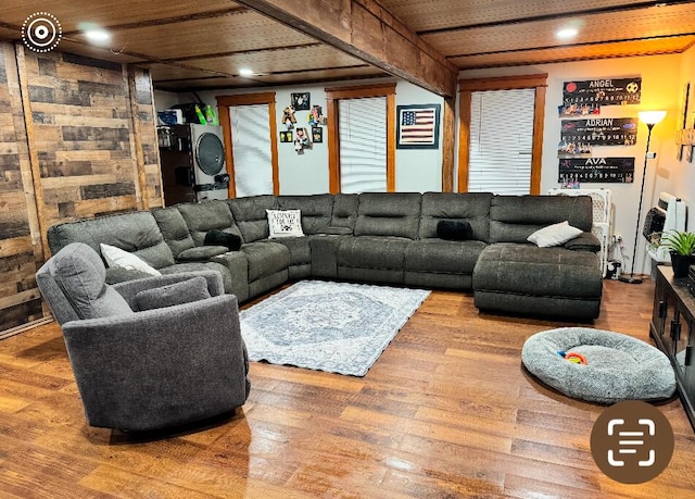 living area with beamed ceiling, wood finished floors, and wood ceiling