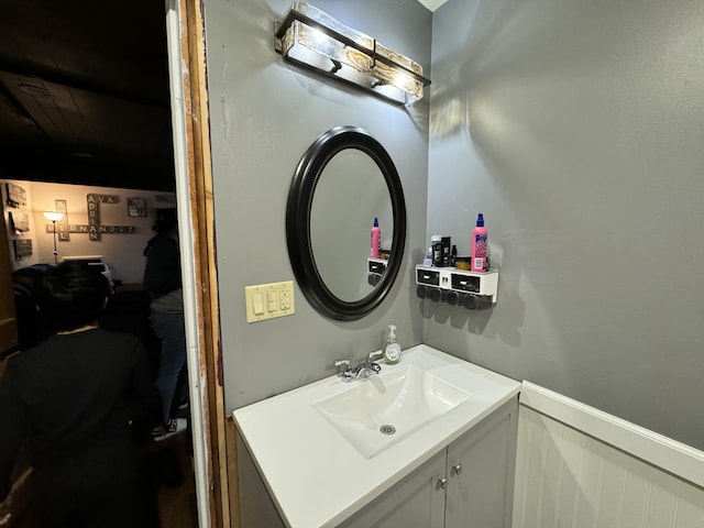 bathroom with a wainscoted wall and vanity