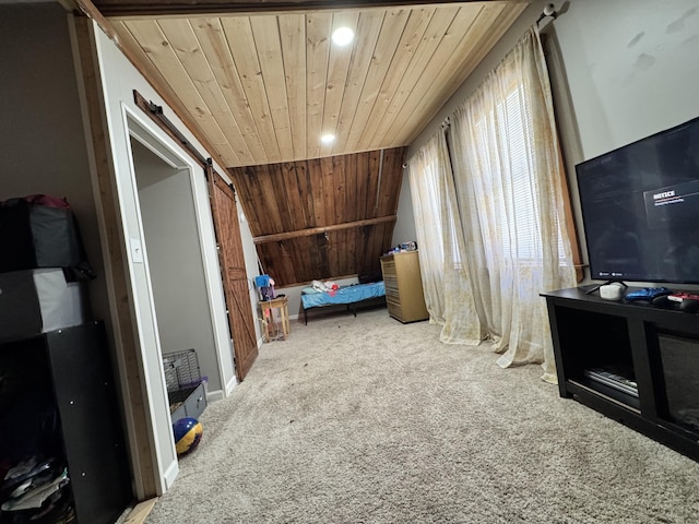 additional living space with lofted ceiling, carpet floors, a barn door, and wooden ceiling