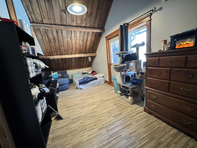 bedroom with lofted ceiling, light wood finished floors, and wood ceiling