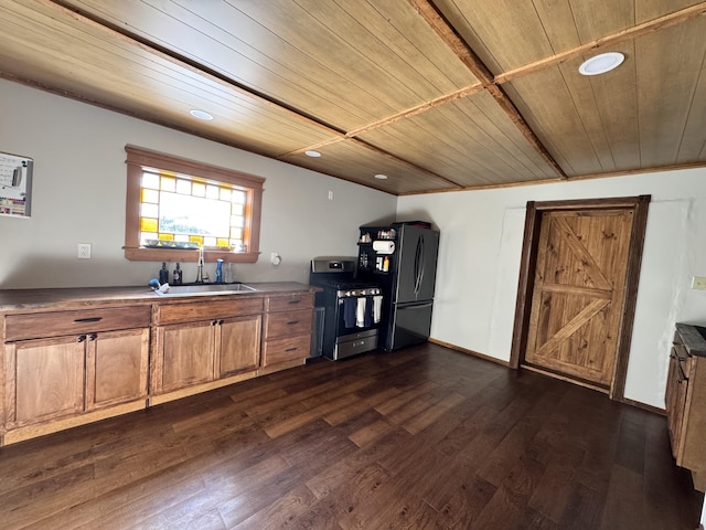 kitchen featuring a sink, wood ceiling, stainless steel range with gas cooktop, freestanding refrigerator, and dark wood-style floors