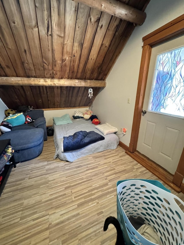 bedroom with light wood-style floors, wood ceiling, vaulted ceiling with beams, and baseboards